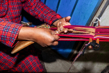 The weaving hands of a woman from the village of Tupe, laborious craftsmanship, with great patience and creativity, bring the fabrics to life. Tupe, Yauyos, Perú.