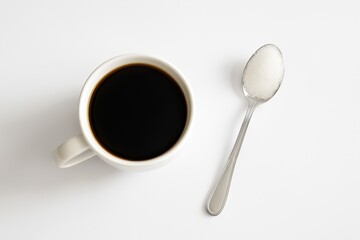 Sipping morning brew coffee in a white cup with spoon minimalist setup studio lighting