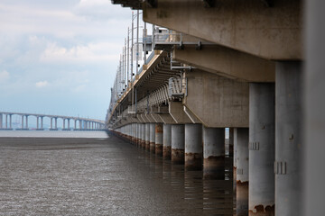 long bridge on mud flat beach and sea