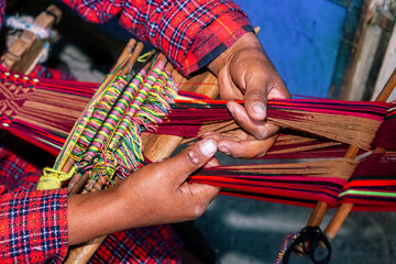 The weaving hands of a woman from the village of Tupe, laborious craftsmanship, with great patience and creativity, bring the fabrics to life. Tupe, Yauyos, Perú.