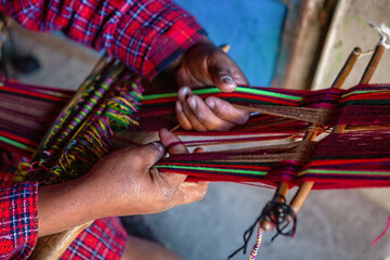 The weaving hands of a woman from the village of Tupe, laborious craftsmanship, with great patience and creativity, bring the fabrics to life. Tupe, Yauyos, Perú.