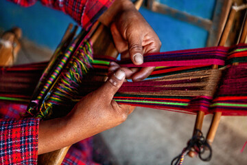 The weaving hands of a woman from the village of Tupe, laborious craftsmanship, with great patience and creativity, bring the fabrics to life. Tupe, Yauyos, Perú.