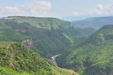 Fototapeta premium Breathtaking horizontal view of the lush Huentitan Canyon from the Viewpoint park, surrounded by greenery and scenic cliffs