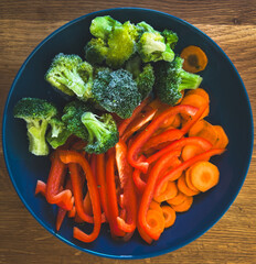 Broccoli, bell pepper and carrots raw in bowl
