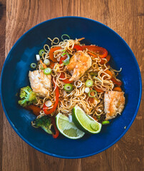 Asian fried noodles with chicken and vegetables served in bowl