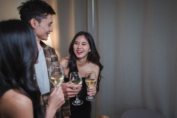 Young Asian friends enjoying party celebrating with wine