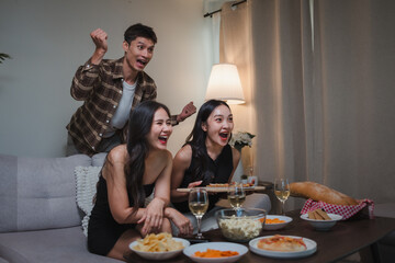 Friends cheering watching television during exciting party