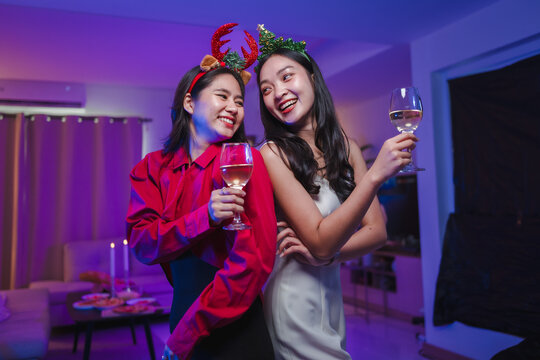 Young Asian women celebrating christmas party holding drinks