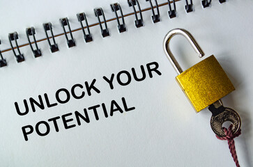 UNLOCK YOUR POTENTIAL, Motivational notepad with padlock and key representing growth and...