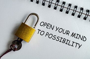 OPEN YOUR MIND TO POSSIBILITY, Inspirational notepad with padlock and key emphasizing opportunity.