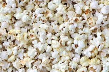Large group of fresh cooked popcorn displayed for sale at a street food market