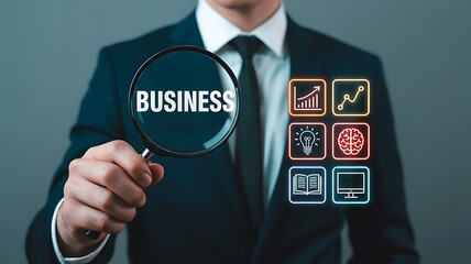 Business analysis and insights concept with businessman holding magnifying glass showing the word business alongside data analytics icons demonstrating success