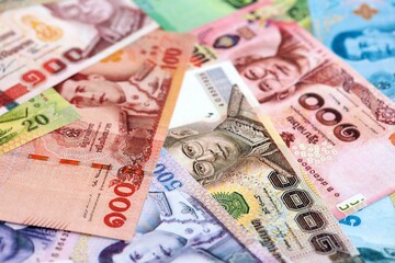 Thai baht currency money. The current banknotes lies on table in big amount