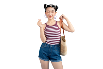 Portrait young Asian woman winking and holding heart gesture, wearing glasses, enjoying summer with her beach bag on PNG