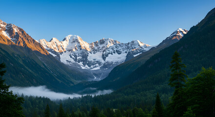 Fototapeta premium Snowy Mountain Peaks Above Forest Valley View