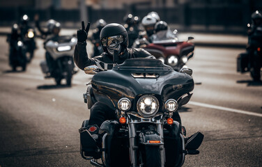 Biker wearing skull mask riding motorcycle on city street