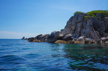 Majestic Rocky Cliffs Rising Above the Clear Turquoise Sea