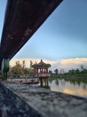 Pagoda and bridge located in the fish pond, this place is located in the Phak Kak Liang temple, one...