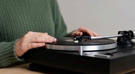 Caucasian female young adult using turntable with vinyl record
