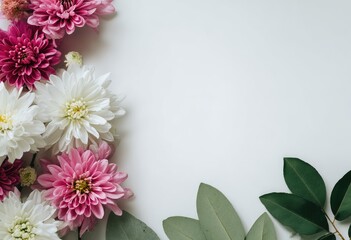 Floral arrangement featuring pink, white, and fuchsia flowers with green leaves on a white backdrop