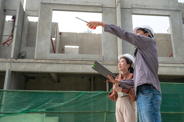 Japanese male site project engineer working with female architect in housing project site