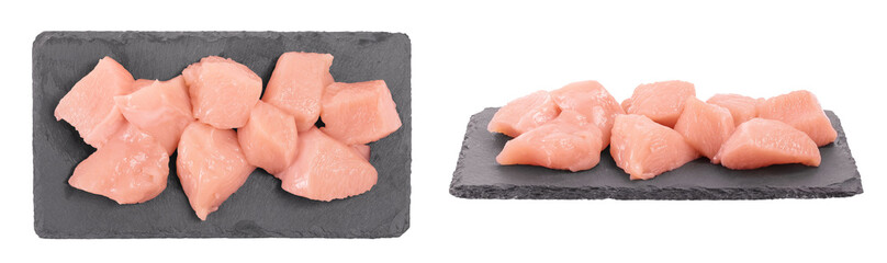 Raw diced chicken fillet on the black board isolated on white background with full depth of field.