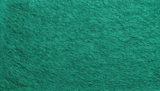 Textured, close-up shot of a teal green fabric surface. Appears soft and fuzzy