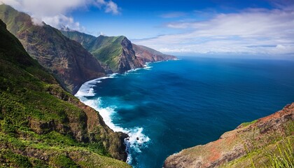 high angle view of a dramatic coastline showcasing rugged mountains meeting the deep blue ocean