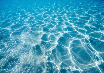 Obraz premium Underwater view of clear blue water with sunlight reflections