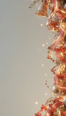 Festive Christmas garland with golden bells red ribbons and sparkling lights against a neutral background