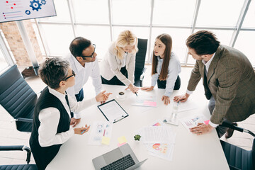 Collaborative business team meeting at a modern office workspace showcasing teamwork, planning, and corporate professionalism