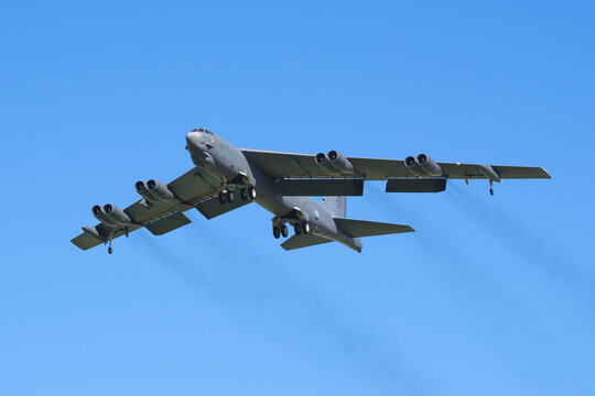 Ostrava, NATO Days, Czech Republic - September 20, 2025: Strategic bomber B-52 Stratofortress flying in the blue sky with landing gear down.  