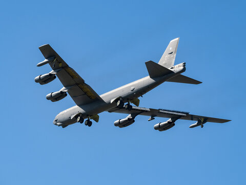 Ostrava, NATO Days, Czech Republic - September 20, 2025: Strategic bomber B-52 Stratofortress flying in the blue sky with landing gear down.  