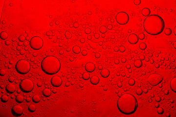 Close-up of red macro surface water,Oil bubbles. Oil bubbles on water. Abstract texture in red tones. Macro photography.