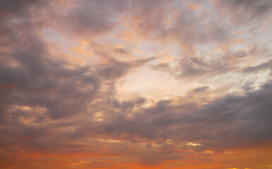 Obraz premium Awesome sunset and soft pink clouds of pastel tones. Image template of textured sky. Gorgeous photo wallpaper. Bright epic sky. Dramatic evening light and fiery orange sunset. Beauty of earth.