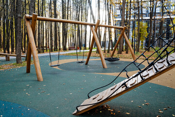 Modern Playground Equipment Made of Wood, Nestled Amongst Nature, Creating an Inviting Atmosphere During the Beautiful Autumn Season, Perfect for Fun Activities, Leisure, and Recreation
