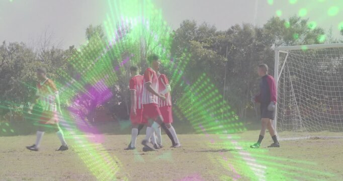 Soccer players forming wall while kicker placing ball and executing shot, defenders celebrating