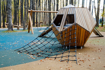 An imaginative and truly unique modern playground structure nestled in a serene environment, surrounded by beautiful trees, inviting children to explore and embark on exciting adventures in nature