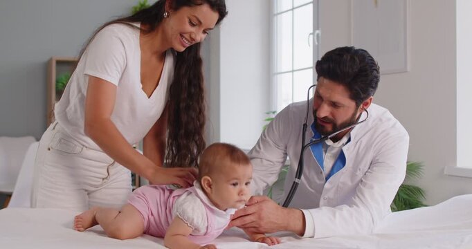 Pediatrician using stethoscope for baby examination with mother support in hospital. Doctor listening heartbeat on professional pediatric checkup to examine heart and lungs health of newborn child