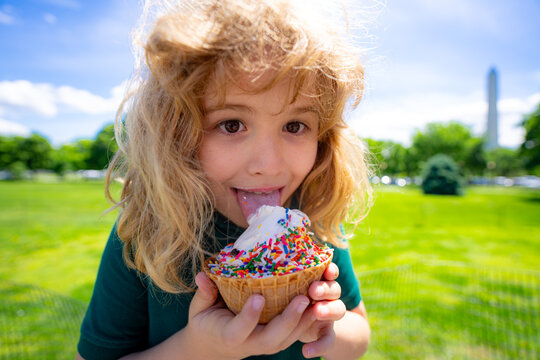 Child eating ice cream. Summer kids funny face. Kid licking icecream cone. Little funny boy with ice-cream. Cute boy enjoying ice cream. Kids fun face. Child with ice cream close-up. - Powered by Adobe