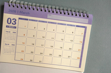 Desktop calendar for March 2026 on a gray background with a copy of the copy.