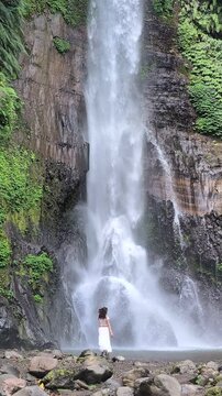 Woman at Gitgit waterfall in Bali , Singaraja, Indonesia