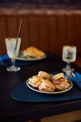 Mini sandwich bites on restaurant dining table.