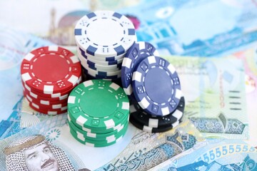 Bahraini dinar currency money bills and bunch of casino chips. The concept of gambling and casino