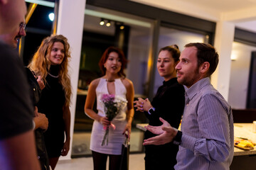 Group of individuals socializing at a modern indoor gathering with friendly conversations
