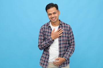 Young happy asian man in casual clothes, smiling looking at camera, touched by compliment,...
