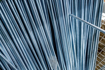 Steel rods stacked neatly in a construction site, showcasing the quality and durability of...