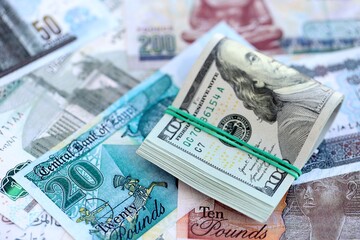 Egyptian pound currency money bills and bunch of us dollars. The concept of currency exchange