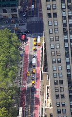 traffic-filled street with buses cars and taxis viewed from a high skyscraper in new york
