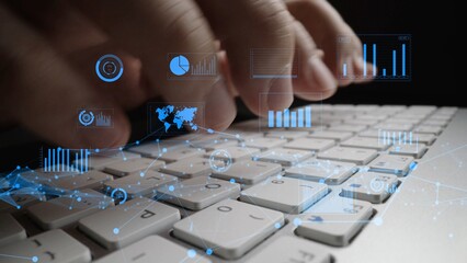 Close-up of hands typing on a laptop keyboard, with digital data visualization elements overlaying. Ideal for concepts related to technology, data analysis, and innovation. Xenic